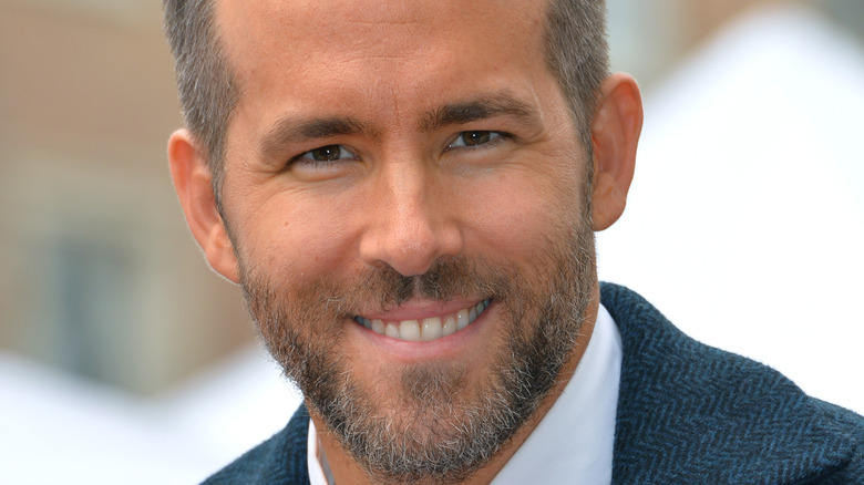 Bearded Ryan Reynolds smiling 