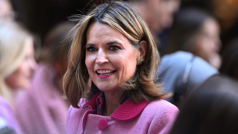 Savannah Guthrie smiling in a pink outfit