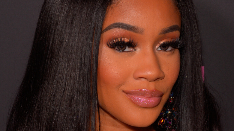 Saweetie smirking with full lashes on 