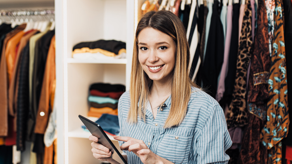 Woman on tablet in closet