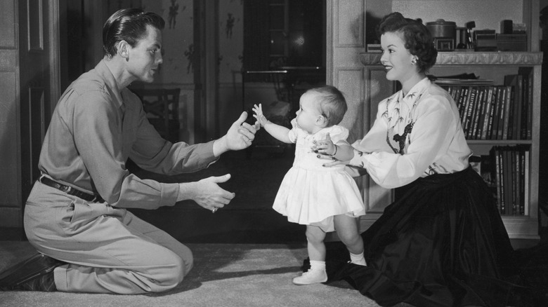 Shirley Temple and baby daughter smiling 