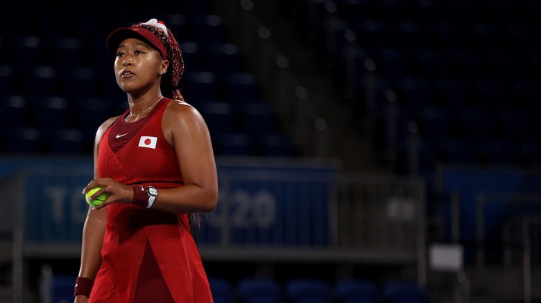 Naomi Osaka playing tennis at the Olympics