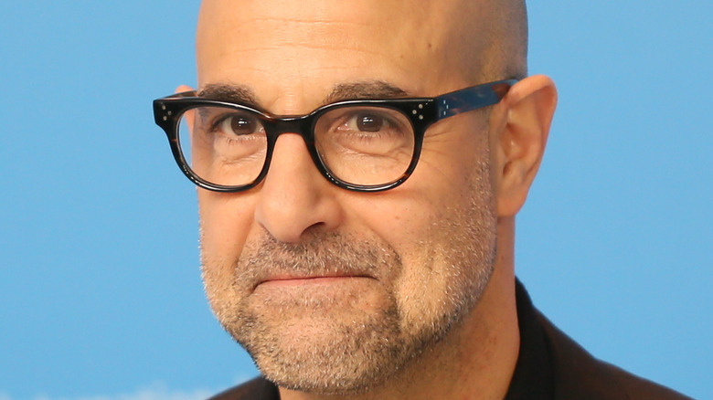 Stanley Tucci poses at a red carpet event