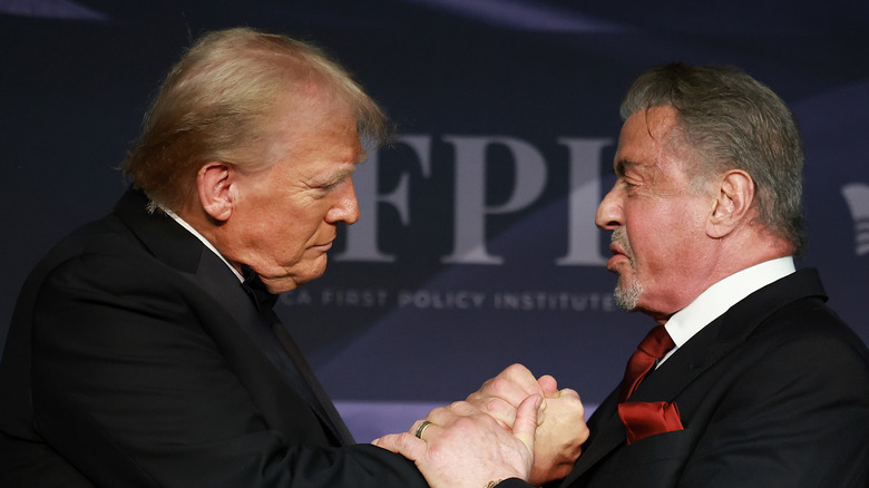 Sylvester Stallone shaking Donald Trump's hand in a suit while at the America First Policy Institute gala.