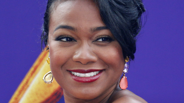 Tatyana Ali poses on the red carpet for Aladdin