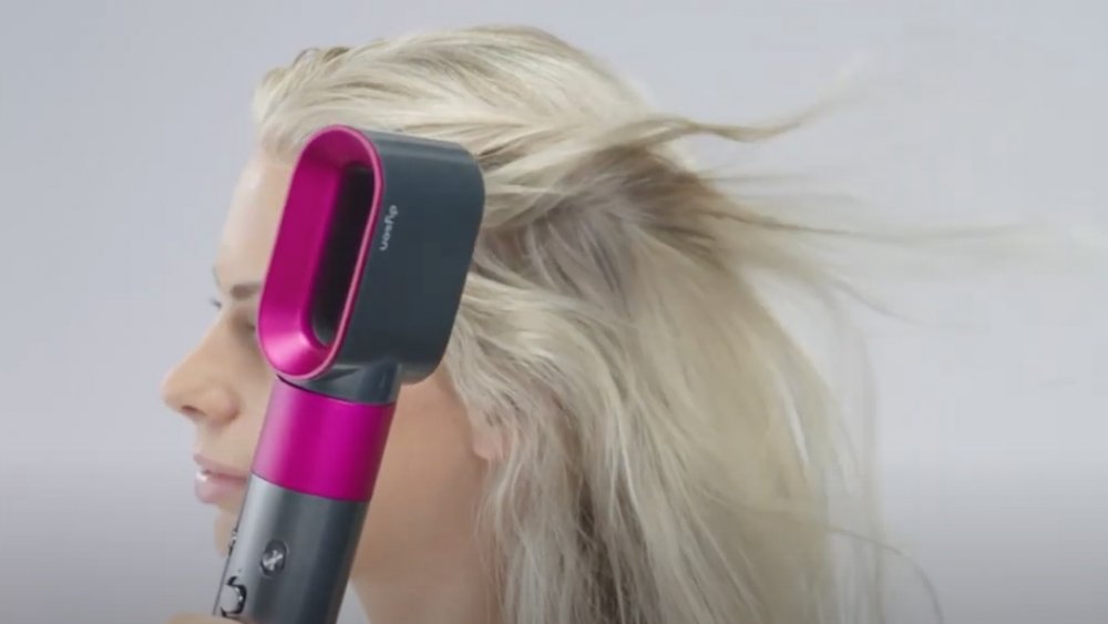 Woman drying her hair with a Dyson Airwrap