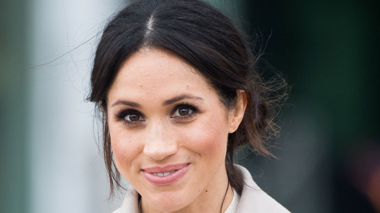 Meghan Markle smiling with an updo