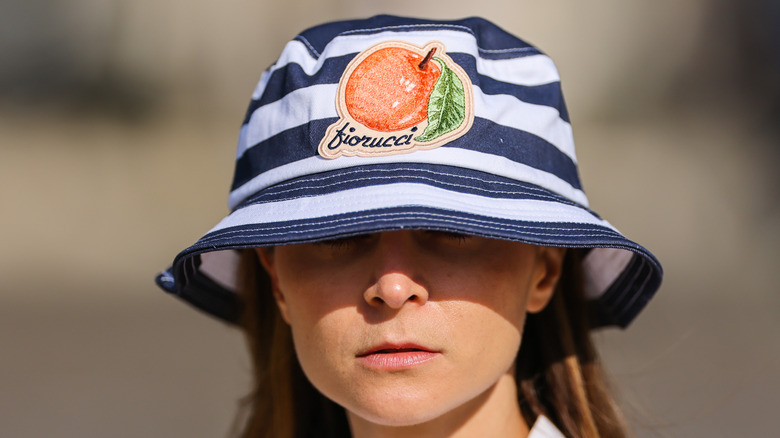 A striped bucket hat with a fruit on it