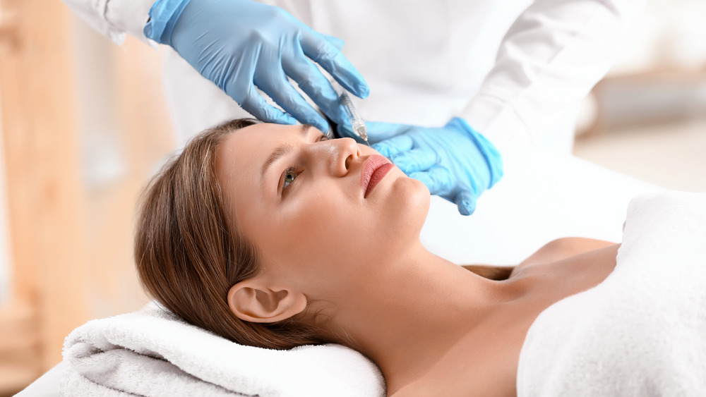 A woman receiving an injection at a beauty salon 