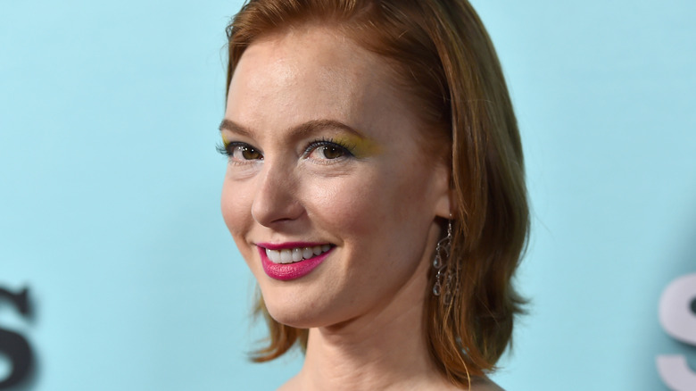 Alicia Witt headshot on blue background