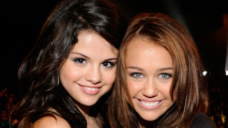 Selena Gomez and Miley Cyrus smiling for the camera together