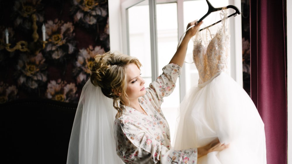 Bride examining wedding dress