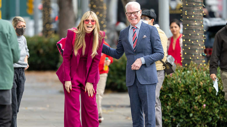Heidi Klum in magenta with Tim Gunn laughing
