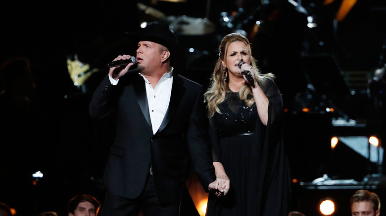 Garth Brooks and Trisha Yearwood perform onstage during the 50th annual CMA Awards in 2016