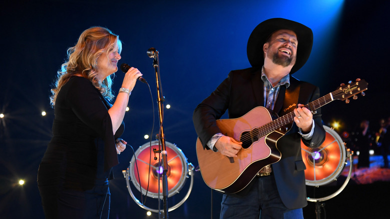 Trisha Yearwood (L) and Garth Brooks perform onstage during MusiCares Person of the Year honoring Dolly Parton at Los Angeles Convention Center on February 8, 2019 in Los Angeles, California.