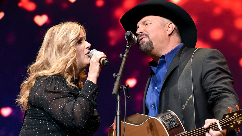 Trisha Yearwood and Garth Brooks perform onstage in 2019