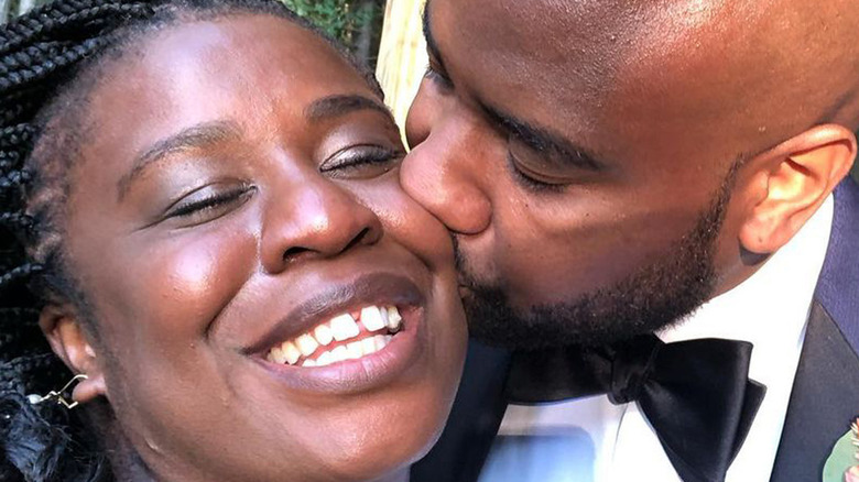 Robert Sweeting and actor Uzo Aduba kissing at their wedding