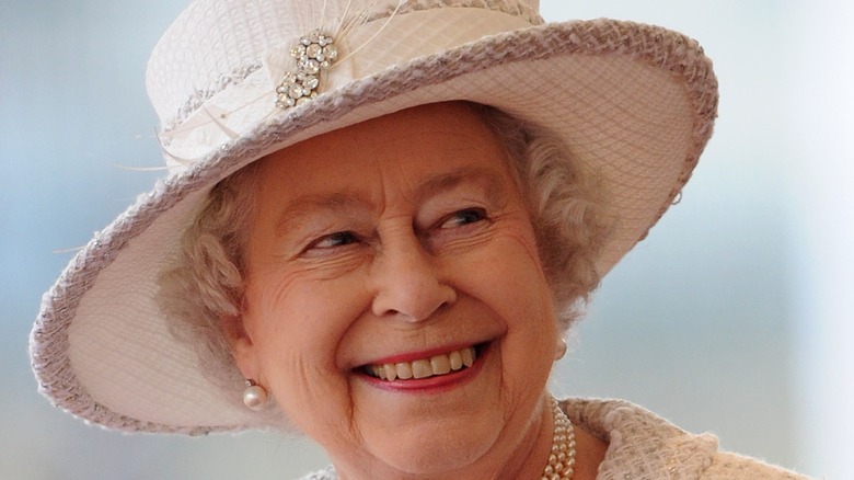 Queen Elizabeth II smiling with diamond broach