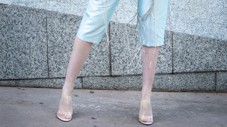 A model's legs and feet in capri pants and sandal pumps 