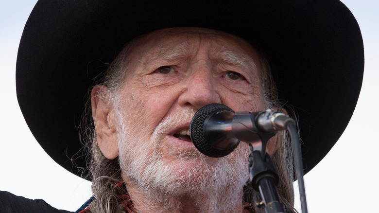 Willie Nelson performing on stage