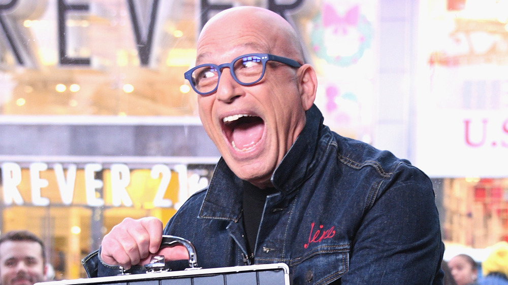 Howie Mandel smiles with case