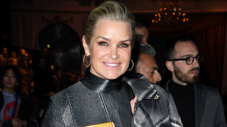 Yolanda Hadid wears a leather jacket and hoop earrings.