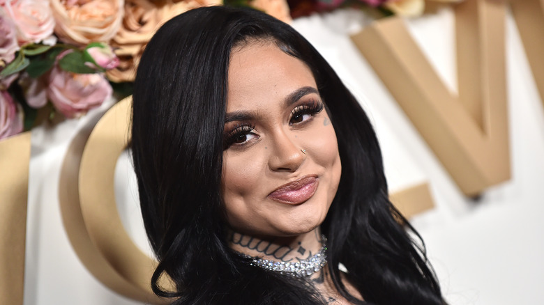 Kehlani smiles with long hair down at red carpet event