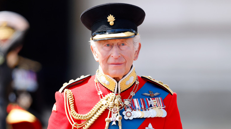 King Charles III is standing outside Buckingham Palace during Trooping the Colour in London (2026)