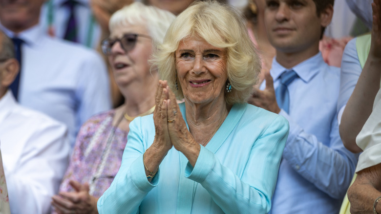 Queen Camilla clapping during the Wimbledon Lawn Tennis Championships at the All England Lawn Tennis and Croquet Club in London.