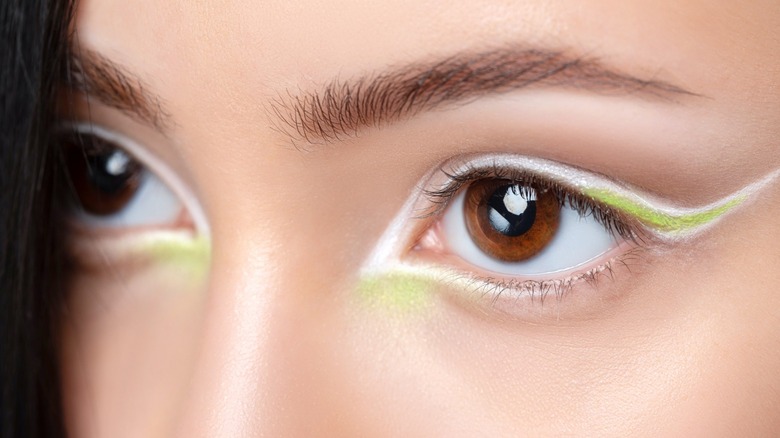 Close-up of white and green eyeliner