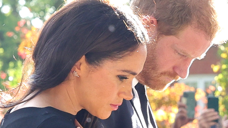 Prince Harry and Meghan Markle look despondent in funeral black