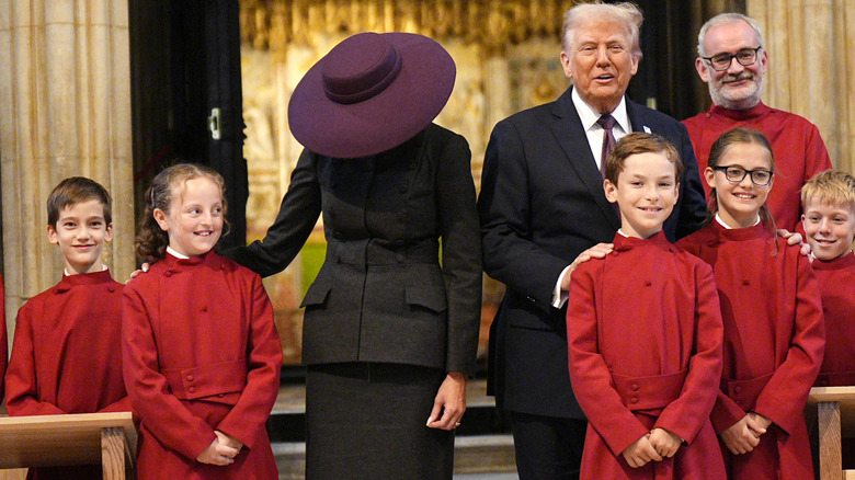 US President Donald Trump and First Lady Melania Trump meet young members of the choir during a visit to St George's Chapel at Windsor Castle during the State visit by the President of the United States of America on September 17, 2025 in Windsor, England (2025)