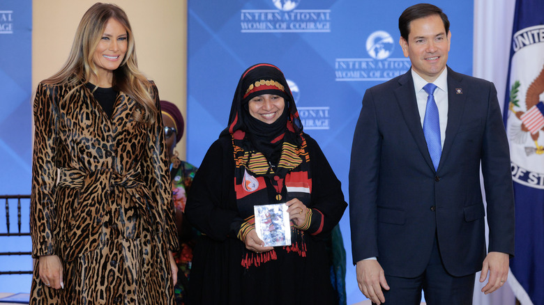U.S. first lady Melania Trump (L) and Secretary of State Marco Rubio pose with International Women of Courage Award recipient Amat Al-Salam Al-Hajj of Yemen during a ceremony in the Ben Franklin Room at the State Department's Harry S. Truman headquarters on April 1, 2025 in Washington, DC (2025)