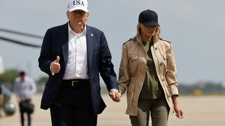 President Donald Trump and first lady Melania Trump visit walk across the tarmac at Lackland Air Force Base after meeting with state and local leaders, first responders and victims of last week's flash flooding on July 11, 2025 in San Antonio, Texas (2025)