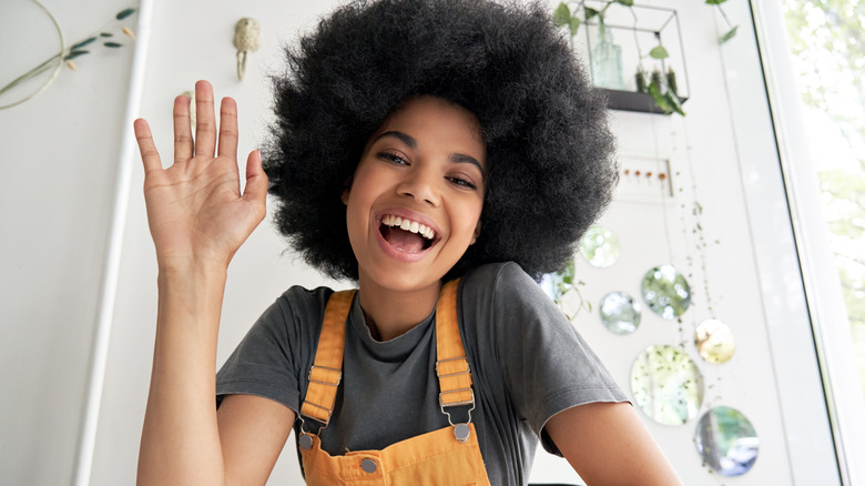 Girl with afro, waving