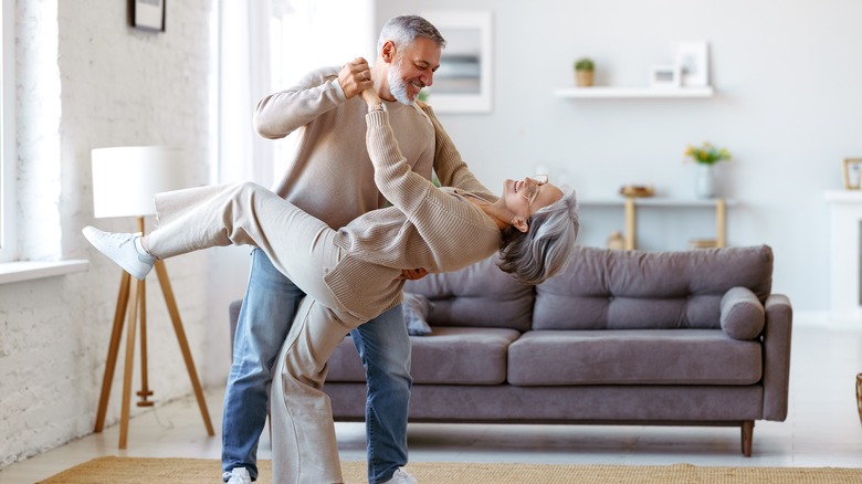 Older couple dancing in living room