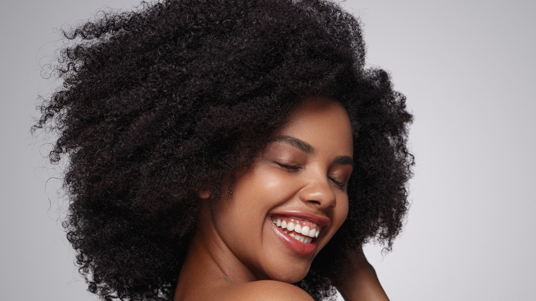 Woman with curly hair smiling