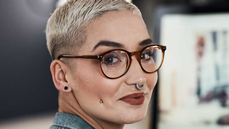 Woman with a facial dermal piercing