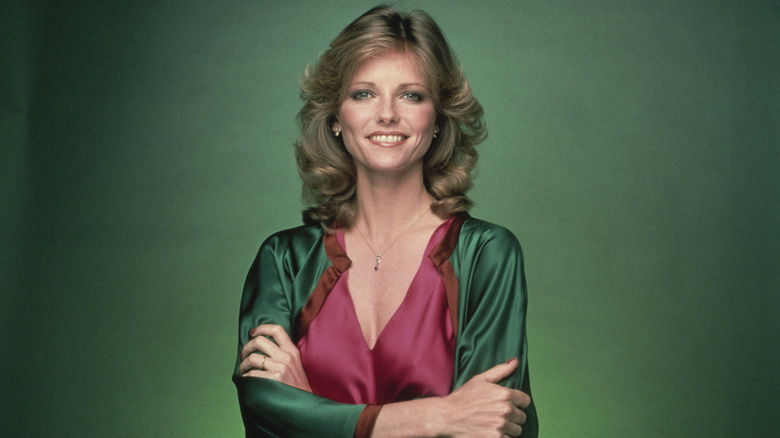 Cheryl Tiegs smiling with her arms crossed.
