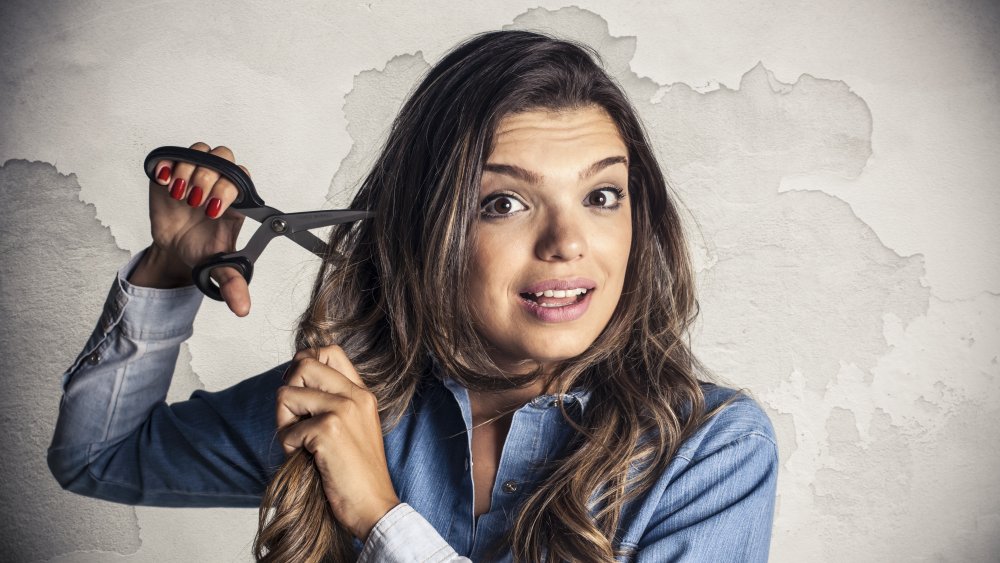 Woman cutting her own hair