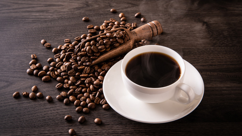 Coffee and coffee beans on wood table