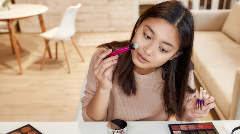 Woman applying makeup