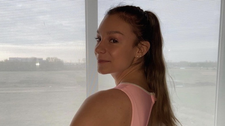 Grace McCallum posing by a window