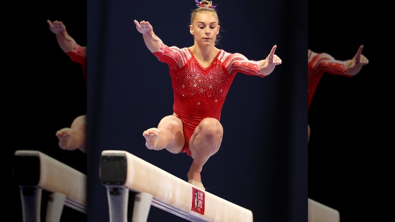 Grace McCallum with one foot on the beam