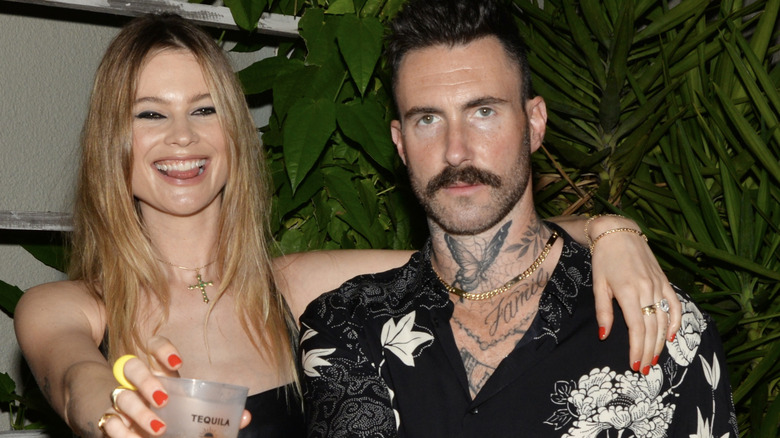 Behati Prinsloo and Adam Levine at the Calirosa Tequila Sunset Happy Hour at South Beach Wine & Food Festival on February 24th, 2022 in Miami Beach, Florida