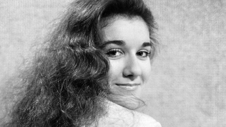 Young Céline Dion looking over her shoulder and smiling