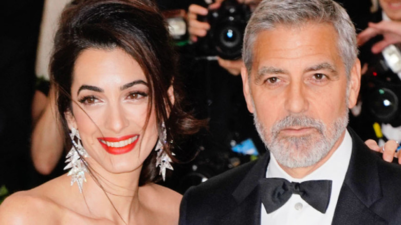 Amal and George Clooney amid a throng of photographers at the Met Gala