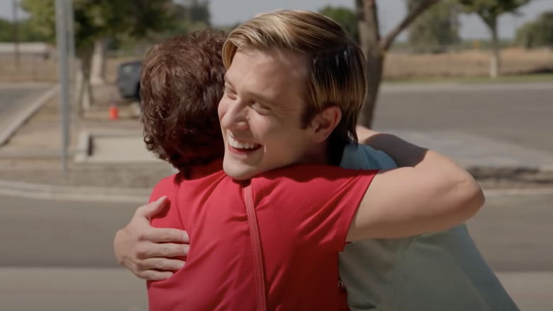 Tyler Henry hugging a client