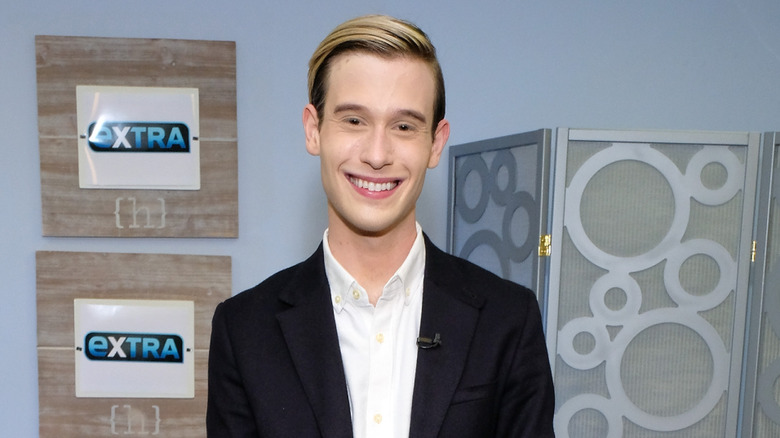 Tyler Henry smiling on set of Extra TV