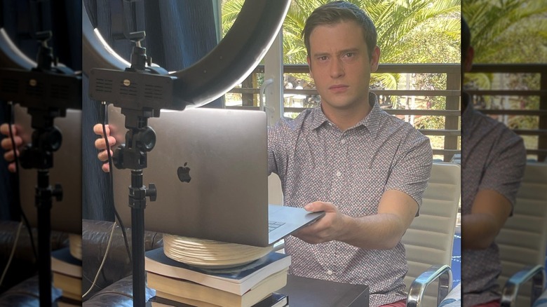 Tyler Henry setting up a laptop in his room for a video call